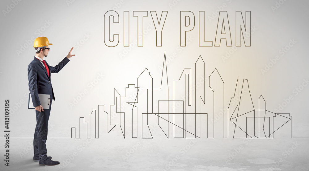 Businessman in hard hat holding blueprint with CITY PLAN inscription, engineering and architecture concept Businessman in hard hat holding blueprint with CITY PLAN inscription, engineering and architecture concept