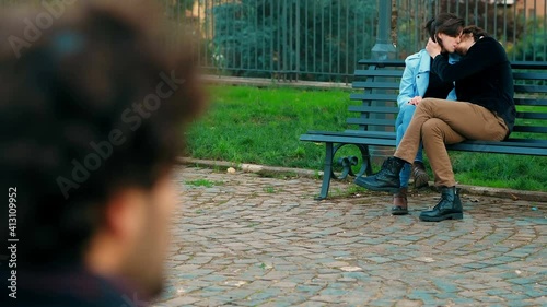 voyeurism, mental deviation - voyeur in the park observes a kissing couple photo