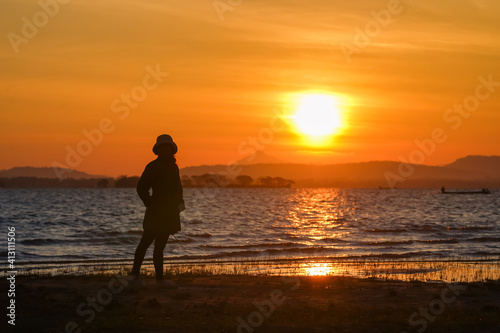 The silhouette of a girl standing in the morning view