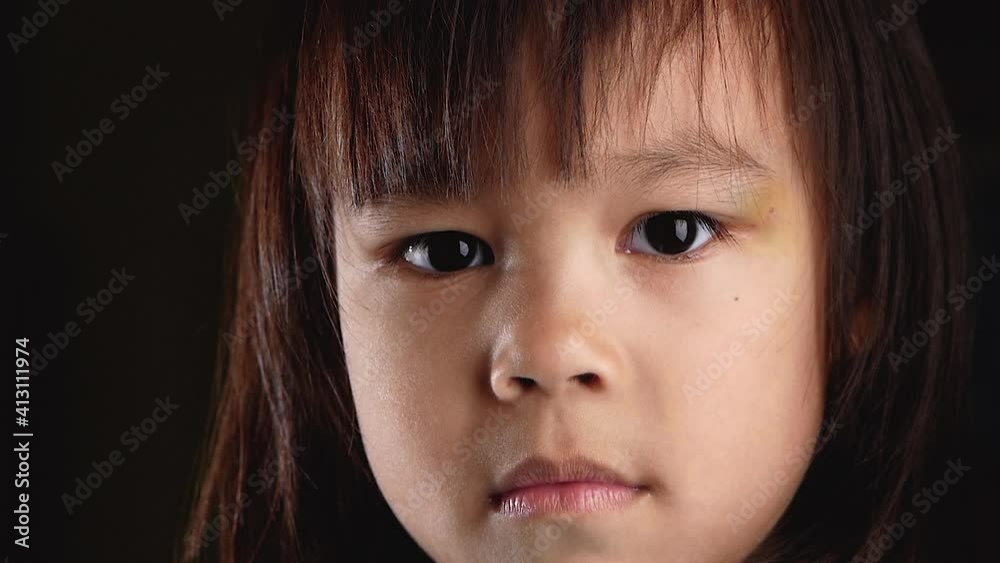 Close-up shot of a little girl enjoy eating eating homemade pizza with hands at home.