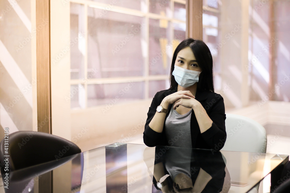 Fototapeta premium Beautiful Asian woman office workers wear face masks meeting together in office for prevent coronavirus infection during covid-19 pandemic. New normal business concept.