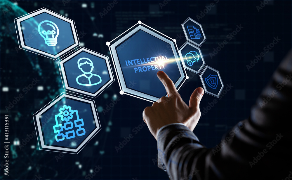 Business, Technology, Internet and network concept. Young businessman shows the word: Intellectual property Business, Technology, Internet and network concept. Young businessman shows the word: Intellectual property