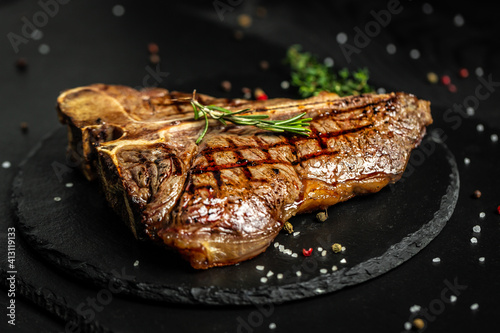 Canvastavla T-bone or aged wagyu porterhouse grilled beef steak with spices and herbs