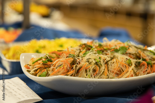 Selective focus of Korean funchose noddles on a white platter photo