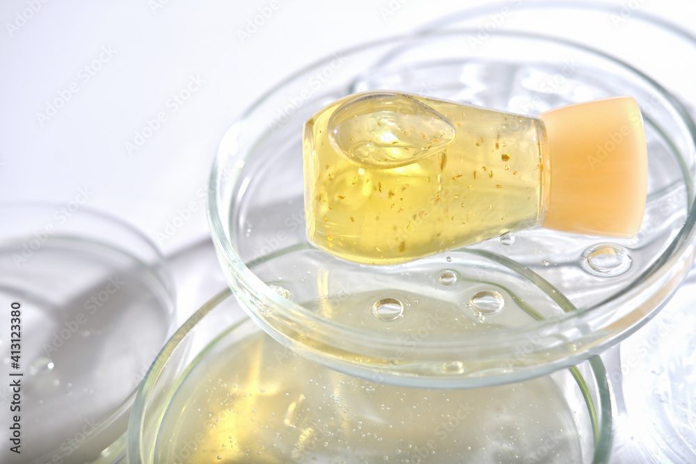 yellow bottle serum solution for sensitive skin on petri dishes.. summer care for reactive skin. lab tested cosmetic product. professional beauty treatment. cosmetology concept. yellow bottle serum solution for sensitive skin on petri dishes.. summer care for reactive skin. lab tested cosmetic product. professional beauty treatment. cosmetology concept.