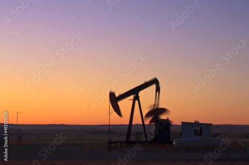 Oil pump jack at sunrise in Alberta, Canada