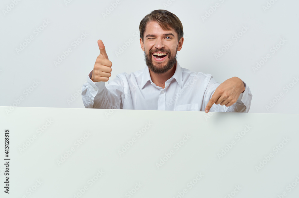 man peeking out from behind banner advertising lifestyle light background man peeking out from behind banner advertising lifestyle light background