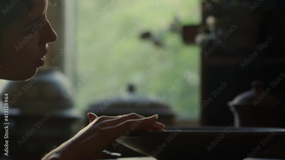 Dreamy woman spinning plate in pottery. Woman meditating on plate in workshop Dreamy woman spinning plate in pottery. Woman meditating on plate in workshop