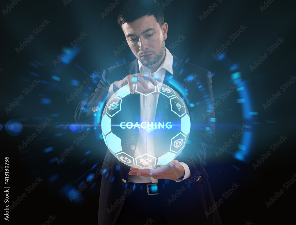 Business, Technology, Internet and network concept. Young businessman working on a virtual screen of the future and sees the inscription: Coaching Business, Technology, Internet and network concept. Young businessman working on a virtual screen of the future and sees the inscription: Coaching