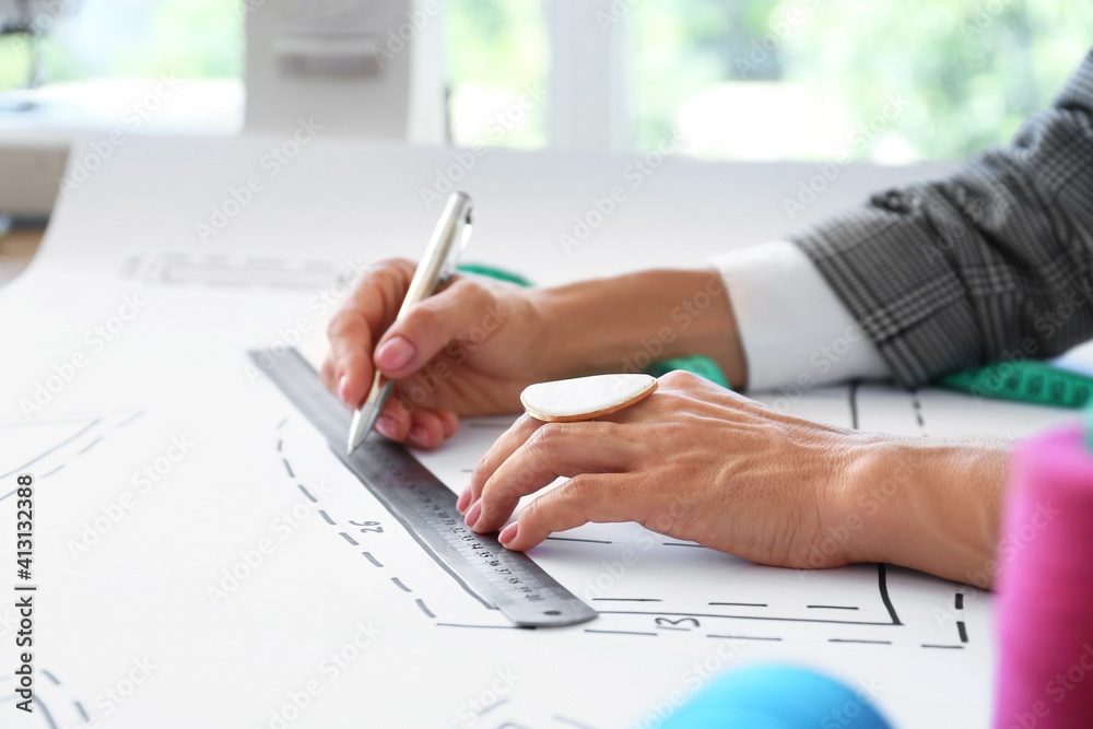 Female fashion designer working in studio, closeup Female fashion designer working in studio, closeup