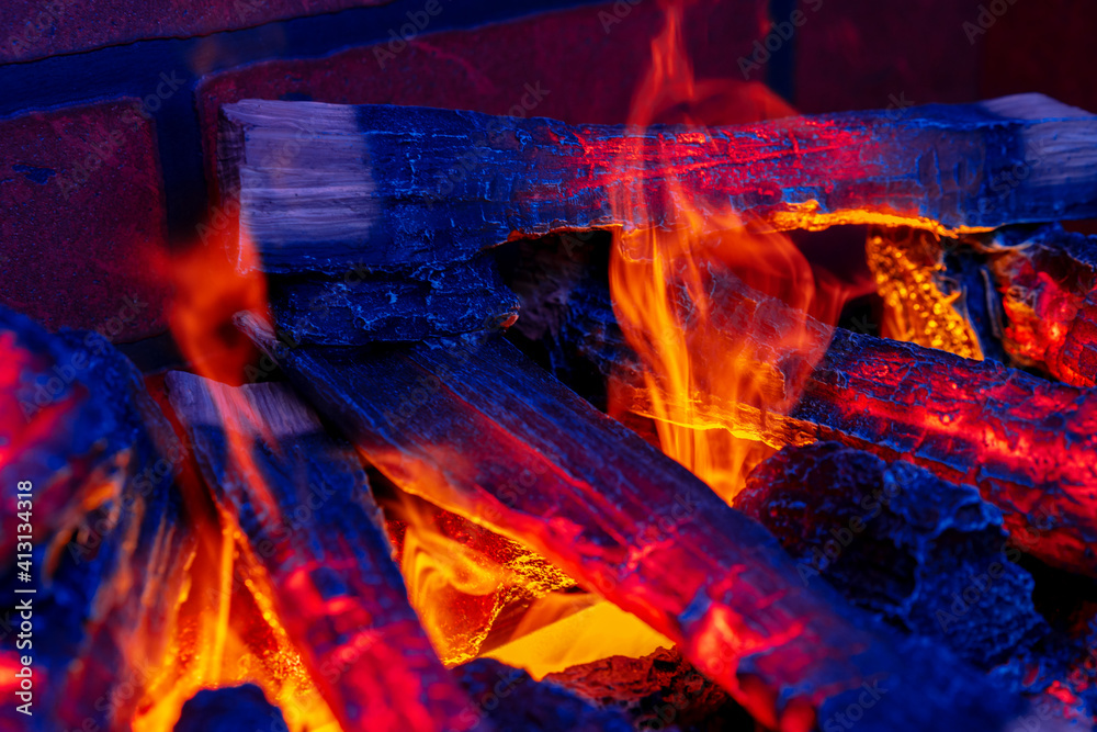 Close up of a fireplace with burning wood logs inside