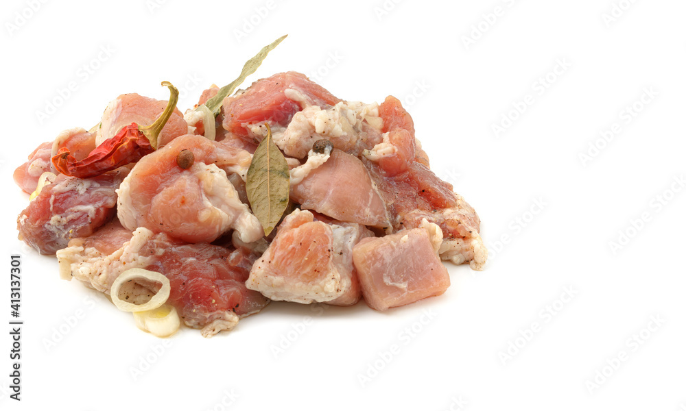 Raw pieces of pork shish kebab in marinade with pepper, onion,bay leaf, ready to cook, barbecue meat, isolated on a white background. Raw pieces of pork shish kebab in marinade with pepper, onion,bay leaf, ready to cook, barbecue meat, isolated on a white background.
