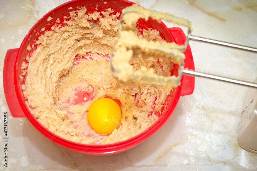 Red bowl with egg yolk and dough Red bowl with egg yolk and dough