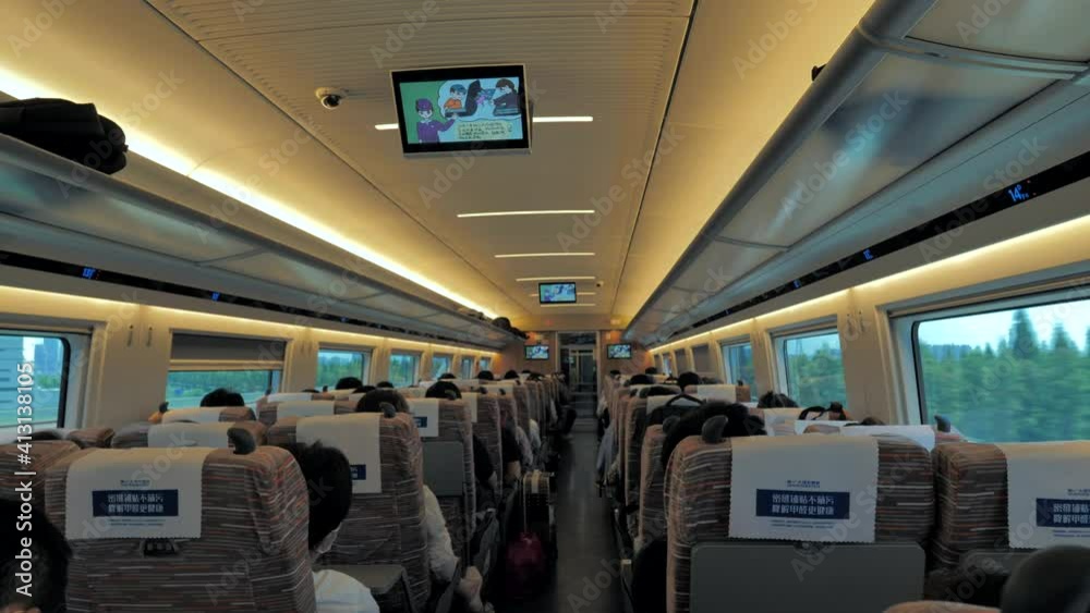 Shanghai, China - August 12, 2020: Inside interior of a coach of the China railway high speed bullet train with passengers. Backview.