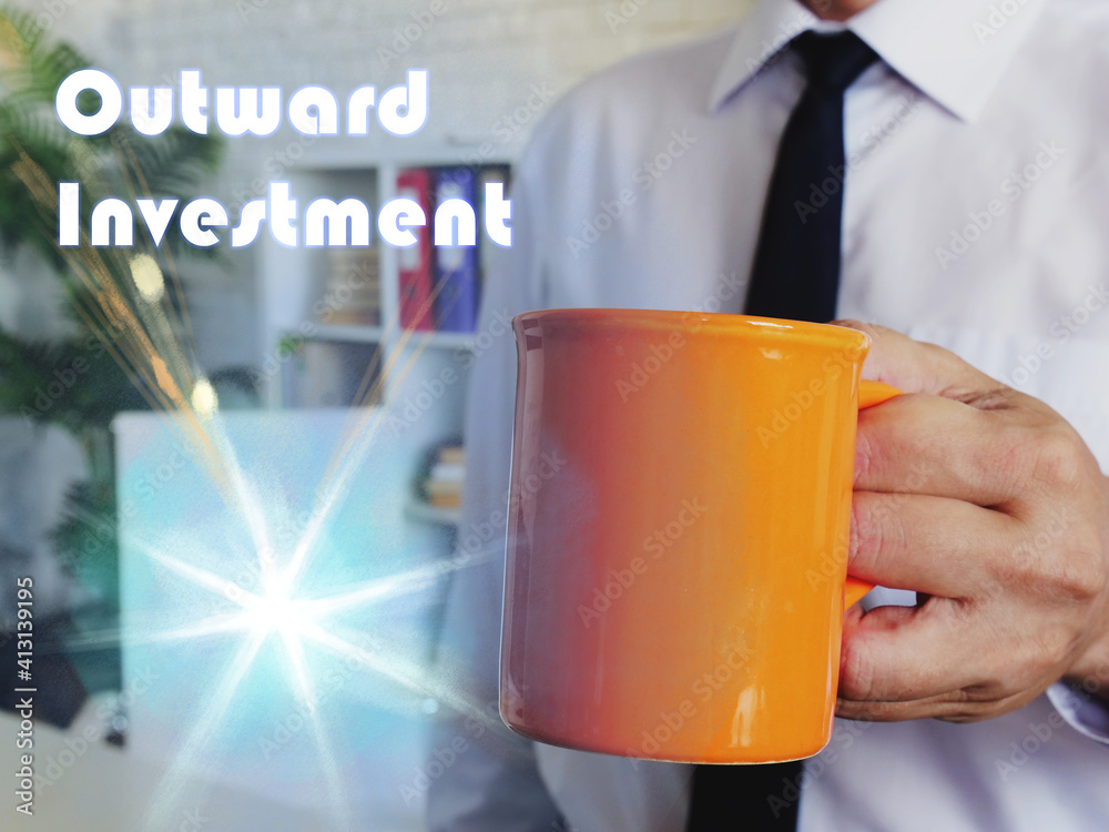 Φωτογραφία Conceptual photo about Outward Investment with Man with a cup of coffee in the background