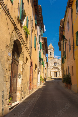 Fototapeta Naklejka Na Ścianę i Meble -  A residential road in the historic medieval village of San Quirico D'Orcia, Siena Province, Tuscany, Italy

