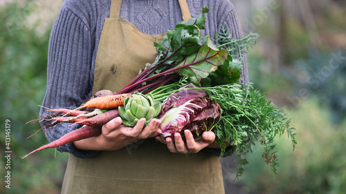 Woman holding organic vegetables. photo