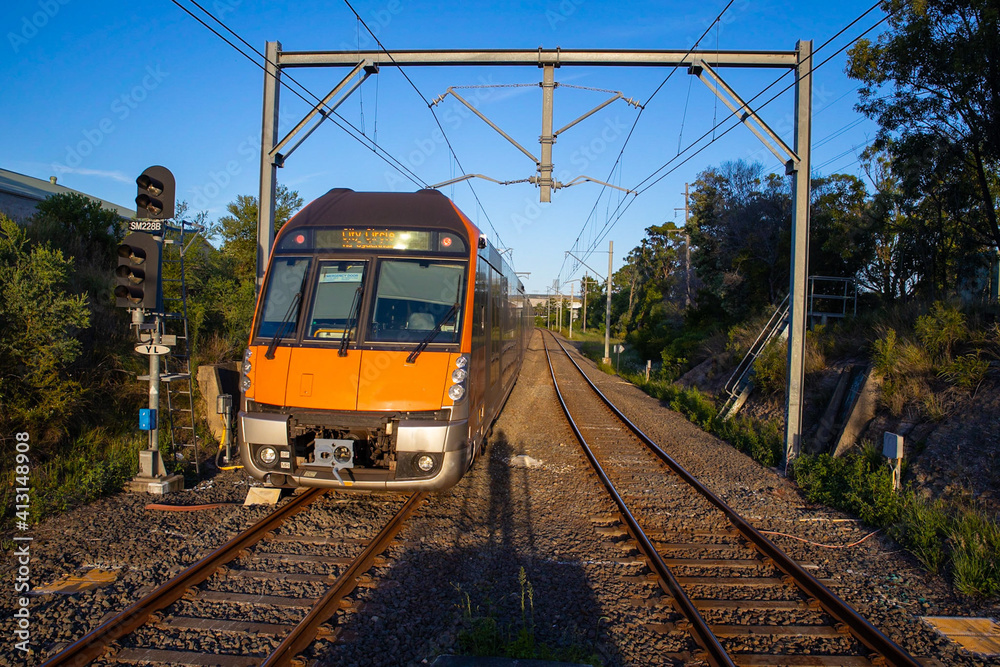 Naklejka premium Commuter Train fast moving through a Station in Sydney NSW Australia
