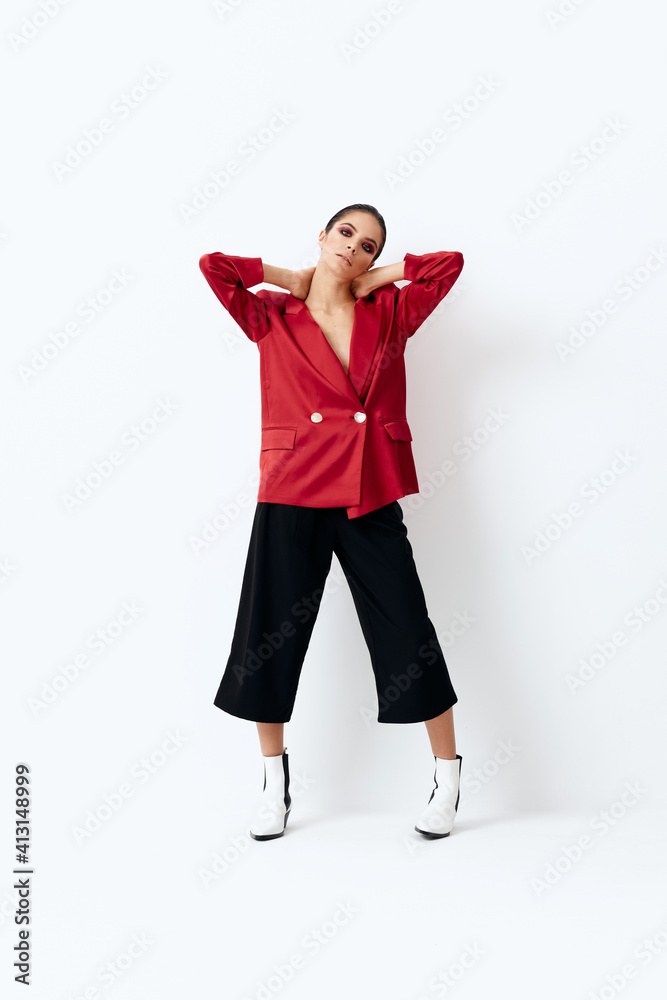 woman in a red jacket bright cosmetics fashionable clothes light background woman in a red jacket bright cosmetics fashionable clothes light background