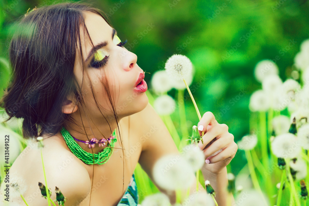Young woman with fashionable makeup in green leaves and dandelion flower on natural background, beauty and fashion, youth and freshness. Young woman with fashionable makeup in green leaves and dandelion flower on natural background, beauty and fashion, youth and freshness.