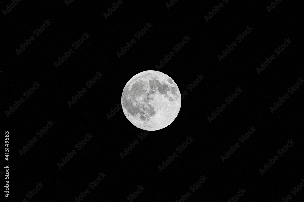 Fototapeta premium Grey full moon in black night sky close up
