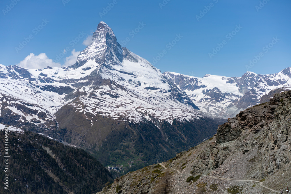 a spring morning view of a hiking trail and the matterhorn mountain from near zermatt