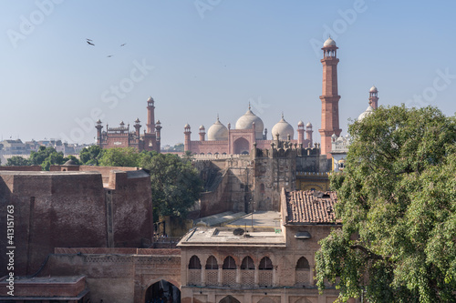 View on beautiful ancient Badshahi mosque built by mughal emperor Aurangzeb taken from the fort of Lahore, Punjab, Pakistan photo