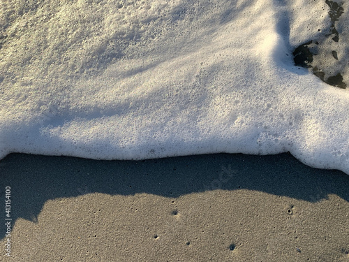 Closeup shot of the Myrtle beach washed by Atlantic ocean waves foam in South Carolina photo