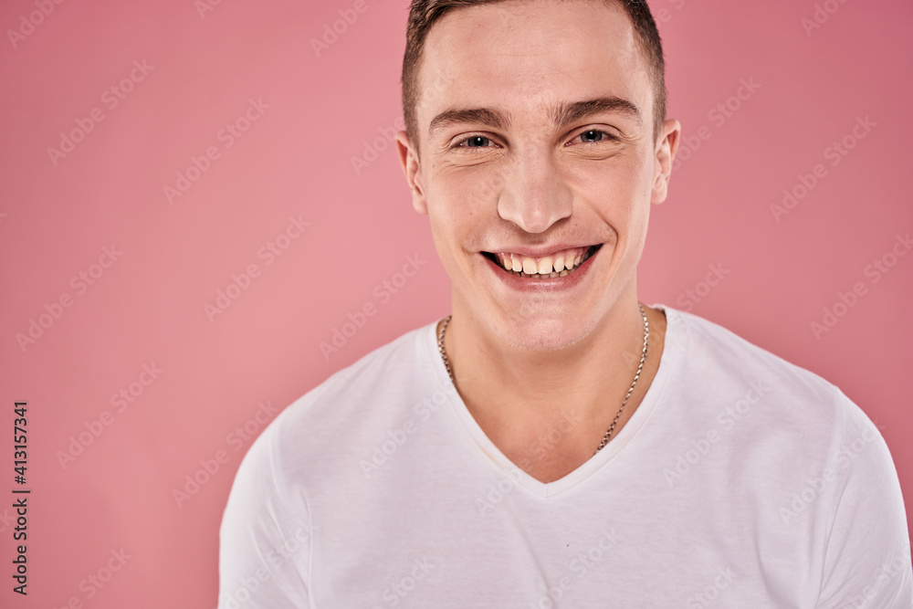 cheerful man in white t-shirt smile emotions close-up pink background studio cheerful man in white t-shirt smile emotions close-up pink background studio