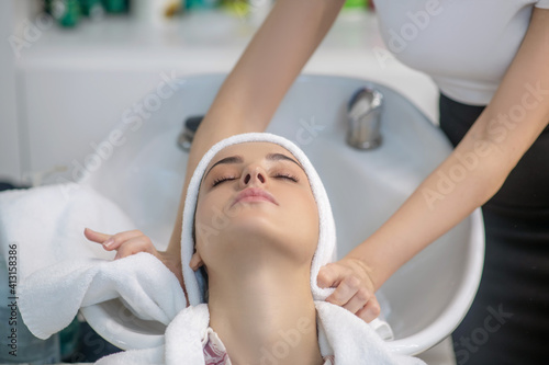Hairdresser drying her clients hair with a towel