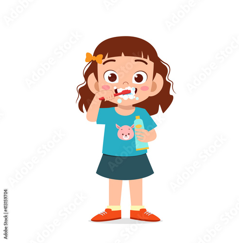 cute little girl brushing teeth and holding toothpaste