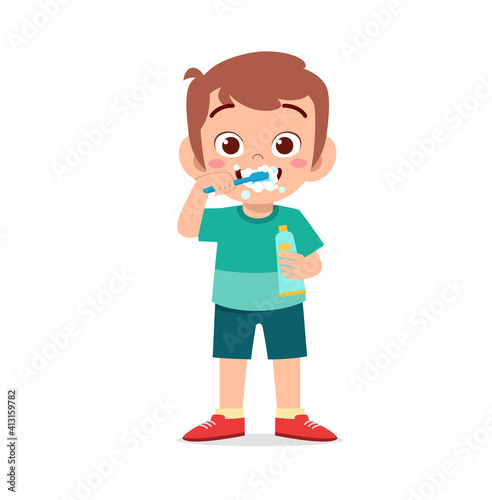 cute little boy brushing teeth and holding toothpaste
