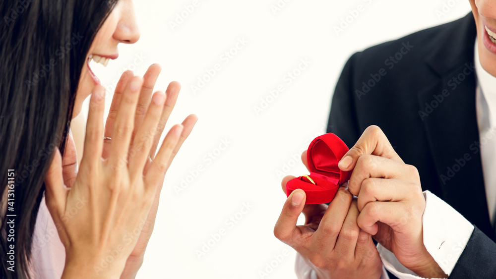 Asian man boyfriend give a box of ring to his girlfriend, she feels excited and very happy Asian man boyfriend give a box of ring to his girlfriend, she feels excited and very happy