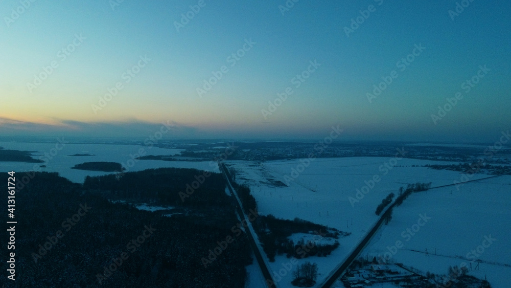 Top view of sunset over winter black forest
