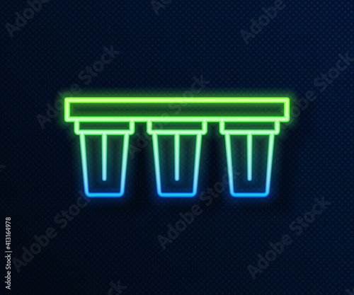 Glowing neon line Water filter icon isolated on blue background. System for filtration of water. Reverse osmosis system. Vector.