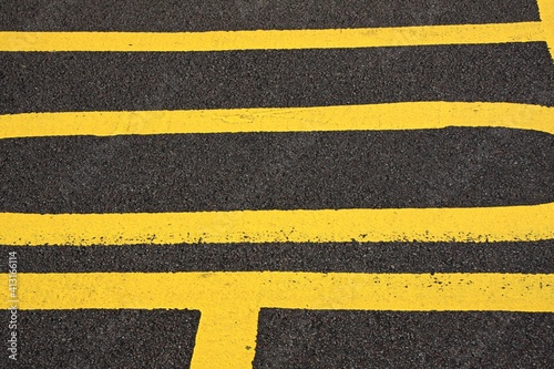 patterns and design from multiple sets of double yellow no parking lines © john