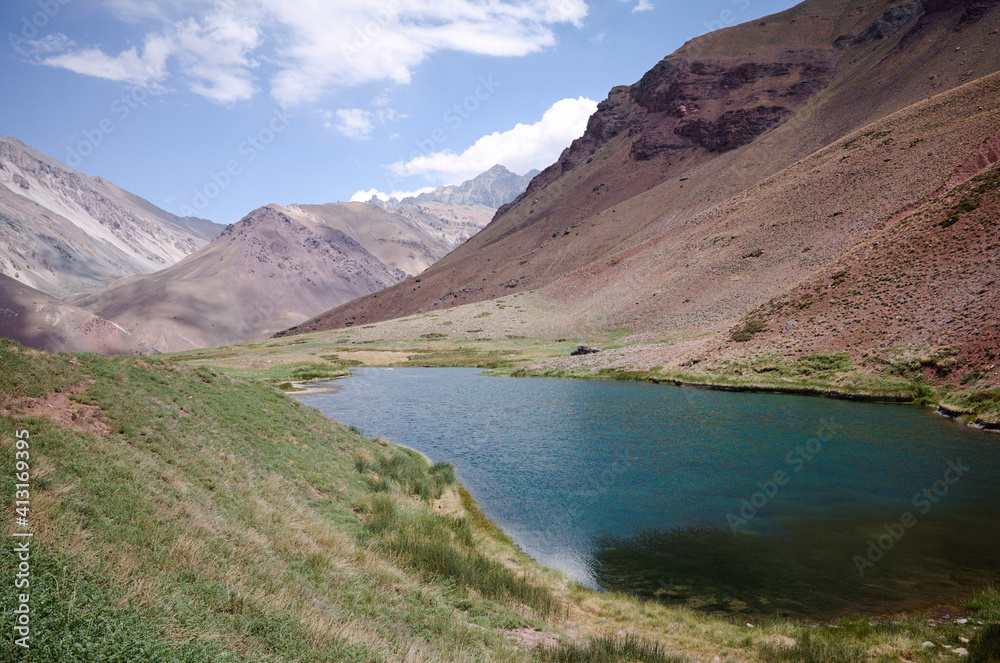 High altitude lake called Laguna de Horcones located in Aconcagua Provincial Park, Andes Mountains, Mendoza Province, Argentina. Blue water against arid mountains and blue sky.