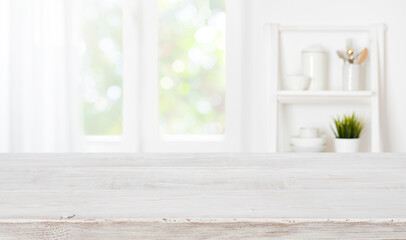 Bleached wooden table top on blurred kitchen summer window background