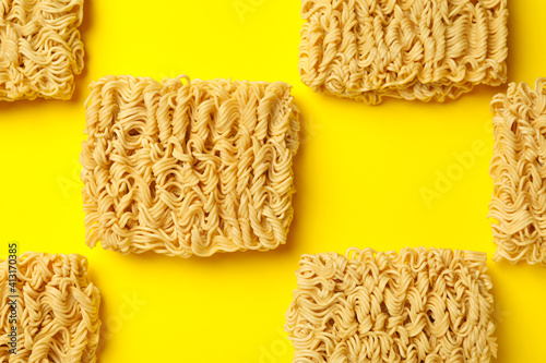 Flat lay with instant noodles on yellow background