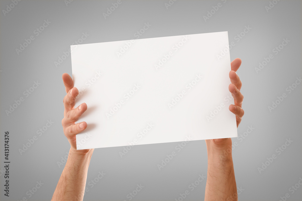 Two hands showing white sheet with stretched fingers isolated background Two hands showing white sheet with stretched fingers isolated background