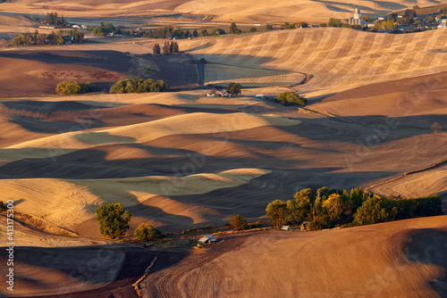 View of the farmland in the Palouse Hills region near Steptoe small rural town in Washington state in the autumn season at sunrise.