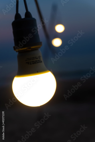  Electric lamps as garland  romantic atmosphere of evening. on beach .
