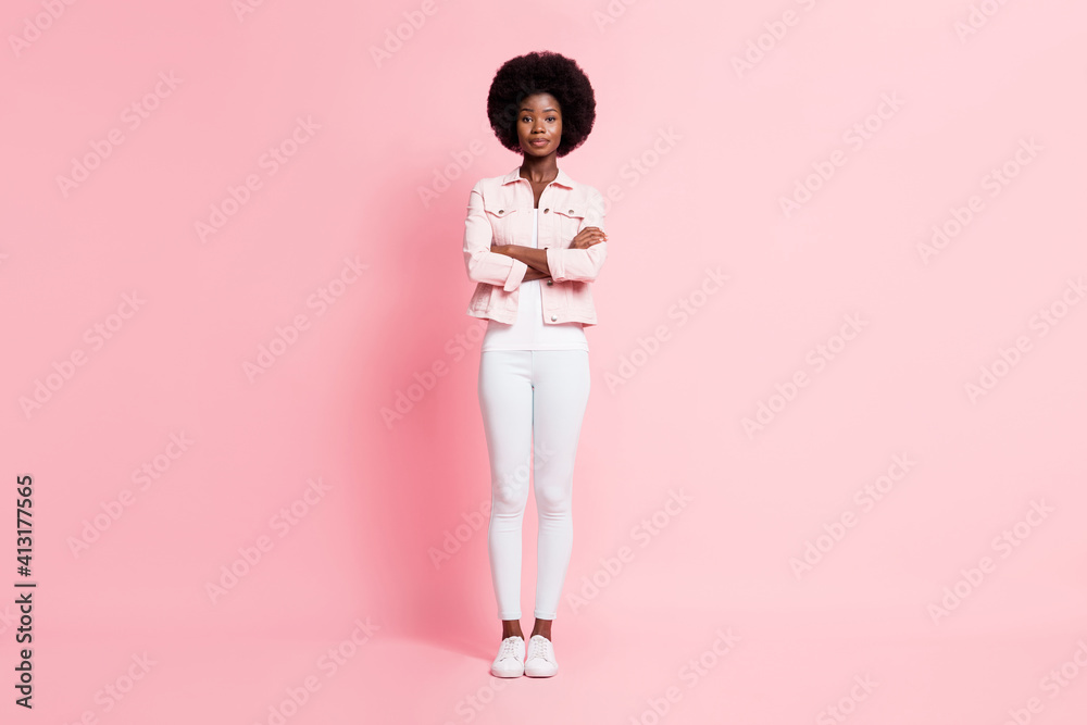 Full length body size view of pretty content slender wavy-haired girl folded arms isolated on pink pastel color background Full length body size view of pretty content slender wavy-haired girl folded arms isolated on pink pastel color background