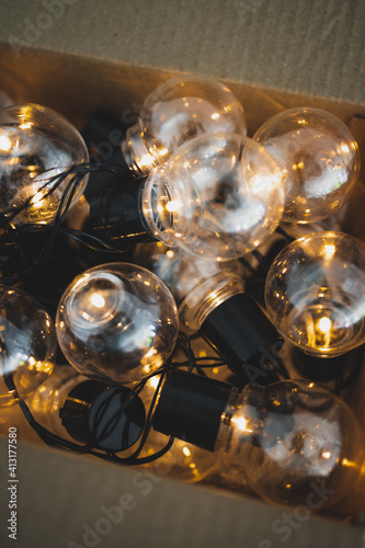 group of light bulbs shining from an open box, mindset and thinking outside the box