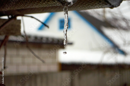 Falling drop of water from icicle