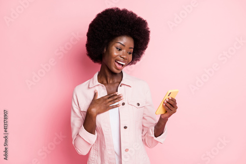 Portrait of pretty cheerful girl using gadget app 5g browsing web having fun isolated over pink color background