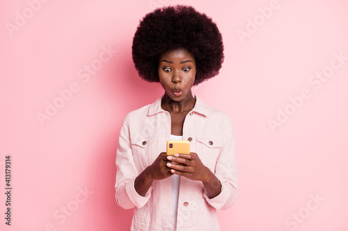 Portrait of lovely funky amazed wavy-haired girl using gadget browse news pout lips isolated over pink pastel color background