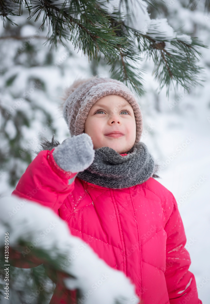 Child in winter. A little girl, playing in the winter outside. Child in winter. A little girl, playing in the winter outside.