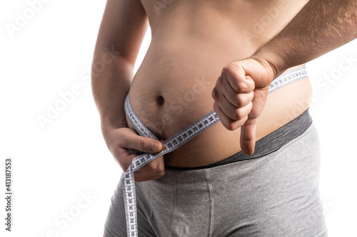 Man is measuring his belly, fat concept