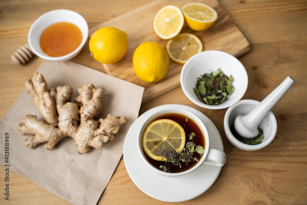 Cup of ginger tea with lemon on wooden table Cup of ginger tea with lemon on wooden table